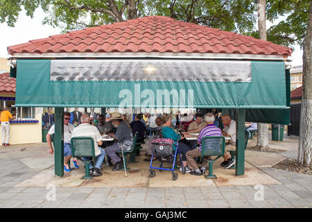 MIAMI, FLORIDA - APRIL 25, 2016: Game players at historic Domino Park along Calle Ocho in Little Havana. Stock Photo