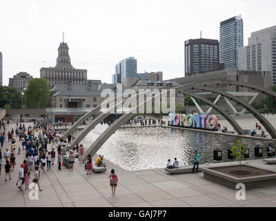 Tourists taking photos in front of Toronto 3D sign in Nathan  Phillips Square, Toronto, Canada. Stock Photo