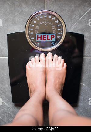the bathroom scales that speaks to you and tells you the truth by writing it on the screen: help! Stock Photo