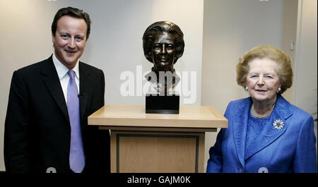 Leader of the Conservative Party David Cameron at the unveiling of a new statue of Lady Thatcher, as she looks on, at the Conservative Party HQ in Millbank, central London. Stock Photo