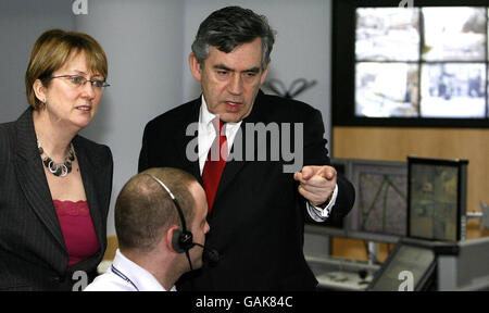Prime Minister Gordon Brown talks with Secretary of State for the Home Department, Jacqui Smith and an officer during their visit to the Specialist Operations Room, where Closed Circuit Television (CCTV) cameras are monitored by the Metropolitan Police Central Communications Command in London. Stock Photo