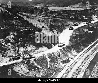 U.S. Rocket planes stop the tanks Shattered by rocket-firing planes of the American Fifth Air Force, seven North Korean heavy tanks sprawl along a narrow road running parallel with the railway to miles north of Chochiwan, South Korea. A destroyed truck has toppled over the embankment (center). Of the Seven tanks, three were destroyed, three received major damage. Stock Photo