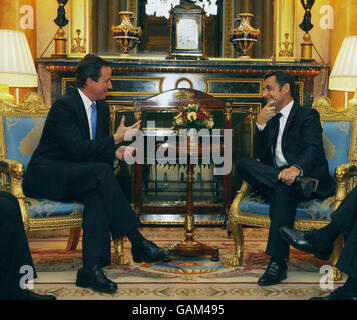 French President Nicolas Sarkozy (right) speaks with the leader of Britain's opposition Conservative Party, David Cameron in a room in Buckingham Palace, in London. Stock Photo