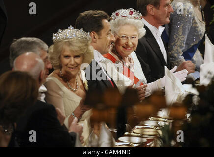 Britain's Queen Elizabeth II, second right, sits beside France's President Nicolas Sarkozy, third right, and Camilla, the Duchess of Cornwall, fourth right, at the start of a state banquet at Windsor Castle in Windsor, England. Stock Photo