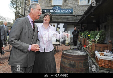 Prince Charles the 'Black Swan' pub in Ravenstonedale, Cumbria with owner Louise Dinnes. The 'Black Swan' pub in Ravenstonedale, has been transformed by the Prince's 'Pub Is The Hub' initiative, which has helped to regenerate 300 locals across Britain. Stock Photo