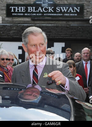 Prince Charles outside the 'Black Swan' pub in Ravenstonedale, Cumbria. The 'Black Swan' pub in Ravenstonedale, has been transformed by the Prince's 'Pub Is The Hub' initiative, which has helped to regenerate 300 locals across Britain. Stock Photo