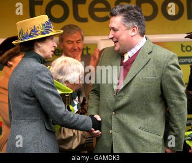 Princess Anne hands the trophy to trainer Paul Nicholls after winning ...