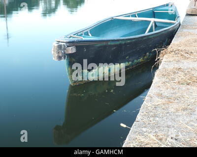 Water,bridge, reflexions and empty boat on bayou St John, New Orleans, Louisiana Stock Photo