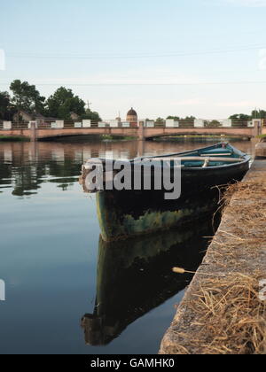 Water,bridge, reflexions and empty boat on bayou St John, New Orleans, Louisiana Stock Photo