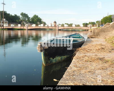 Water,bridge, reflexions and empty boat on bayou St John, New Orleans, Louisiana Stock Photo