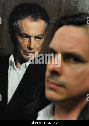 A portrait of former Prime minister Tony Blair by artist Phil Hale (Right) goes on show at Portcullis House in Westminster, central London. Stock Photo