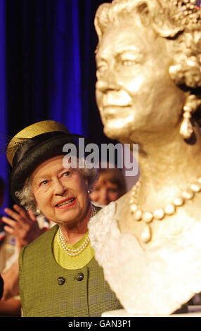 Britain's Queen Elizabeth II unveils a bronze statue of herself at the Scout Association Activity Centre at Baden-Powell House, London. Stock Photo