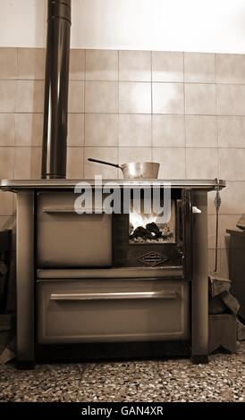 old wood-burning stove in the kitchen of mountain home Stock Photo