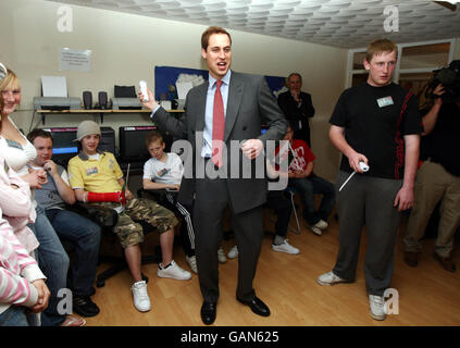 Prince William plays a game on the Nintendo Wii with Martyn James during a visit to the Valleys Kids Project at the Pen Dinas Flats, in Dinas in the Rhondda Valleys. Stock Photo