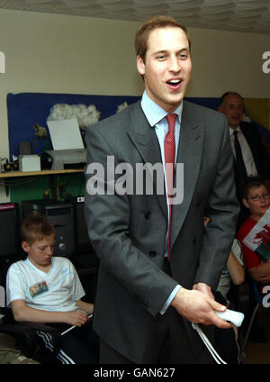 Prince William plays a game on the Nintendo Wii during a visit to the Valleys Kids Project at the Pen Dinas Flats, in Dinas in the Rhondda Valleys. Stock Photo