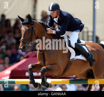 Great Britain's Mark Armstrong riding Thesaura competes in the Royal Windsor Grand Prix at the Royal Windsor Horse Show in Berkshire. The horse show which is set in the grounds of Windsor Castle has been running from the 8th May untill the 11th May. Stock Photo
