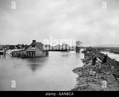 Servicemen and civilian workers toiling at Canvey Island, Essex, to repair the sea defences, damage to which caused the disastrous floods. Stock Photo