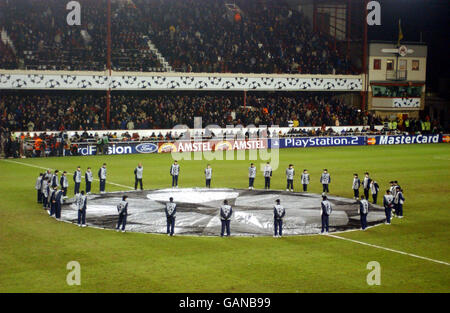 Ballboys surround the giant UEFA Champions League starball logo in the centre circle Stock Photo