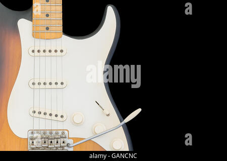 Brown, orange electric guitar isolated on black background. Stock Photo