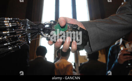 A person shakes hands in the House of Commons, London, with Shadow Robot Company's C5 Dexterous Hand, the only robot hand in the world that is capable of the same movements as the human hand, which is being developed for industrial applications. Stock Photo