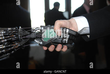 A person shakes hands in the House of Commons, London, with Shadow Robot Company's C5 Dexterous Hand, the only robot hand in the world that is capable of the same movements as the human hand, which is being developed for industrial applications. PRESS ASSOCAITION Photo. Picture date: Tuesday April 22, 2008. The hand was displayed at a special parliamentary reception organised by the Institute of Physics, and the Parliamentary Office of Science and Technology, where the UK's biggest collection of intelligent robots was presented to the government. Photo credit should read: Tim Ireland/PA Stock Photo