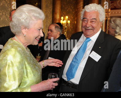 Britain's Queen Elizabeth II chats with celebrity chef Antonio Carluccio during a reception she hosted for the British Hospitality Industry at Buckingham Palace in London. Stock Photo