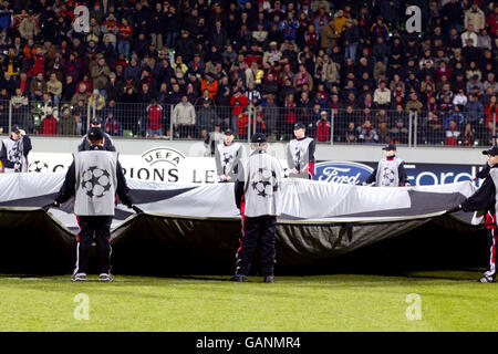 Ballboys surround the giant UEFA Champions League starball logo in the centre circle Stock Photo