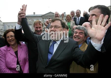 Irish Taoiseach-in-waiting Brian Cowen waves after he was publicly unveiled as Fianna Fail party leader-designate today outside the Dail parliament in Dublin. Stock Photo