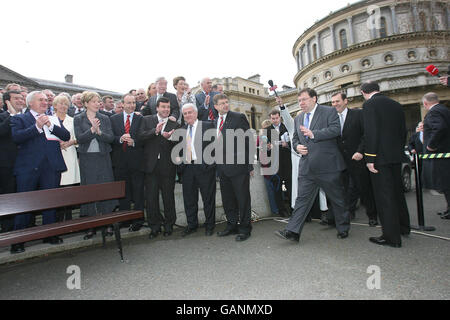 Irish Taoiseach-in-waiting Brian Cowen is applauded by party members after he was publicly unveiled as Fianna Fail party leader-designate today outside the Dail parliament in Dublin. Stock Photo