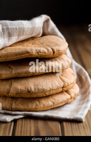 Tasty pita bread on old wooden table. Stock Photo