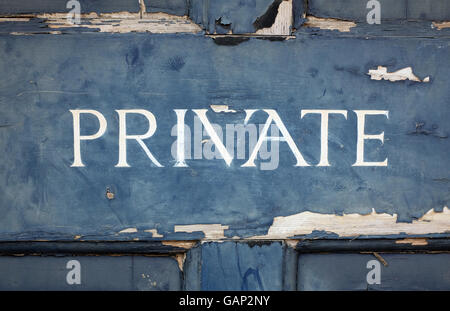 private sign hand painted on weathered wooden door Stock Photo
