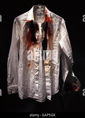 The bloodstained shirt worn by James Bond actor Daniel Craig in his first appearance as the 007 secret agent in Casino Royale, at an exhibition marking the centenary of the birth of British novelist Ian Fleming, creator of James Bond 007, opening at the Imperial War Museum, London from tomorrow. On display are memorabilia and artefacts from the author's life and the Bond films including, Little Nellie, the autogyro from You Only Live Twice, right, and a working model Aston Martin DB5 car, left, owned by HRH Prince Andrew. Stock Photo