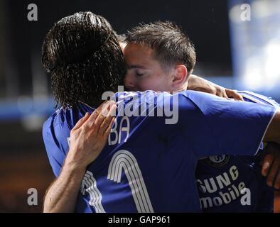 Chelsea's Frank Lampard hugs Didier Drogba after scoring his penalty during the UEFA Champions League Second Leg match at Stamford Bridge, London. Stock Photo