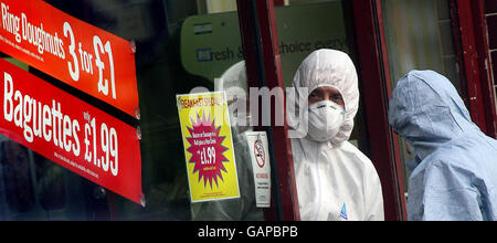 Police forensics officers at the scene where a teenage boy was murdered at the Three Cooks bakery in Lee, south east London. Stock Photo