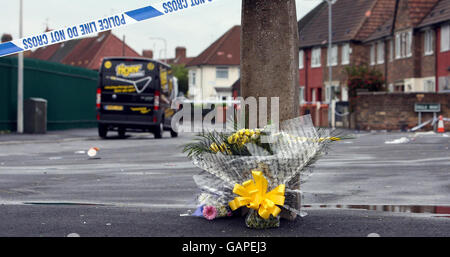 Flowers are left on Astley Road in Huyton, Liverpool, where a six-year-old girl was killed in a hit-and-run crash when she was knocked down by a van last night. Stock Photo