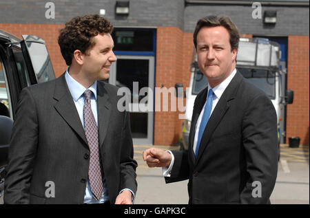 Conservative Leader David Cameron (right) talks to police officers during a visit to Crewe & Nantwich to campaign in the by-election with the Conservative candidate Edward Timpson. Stock Photo