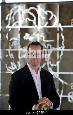 Artist Dylan Hammond at the Welsh assembly building in Cardiff in front of his portrait of Baroness Thatcher. Stock Photo
