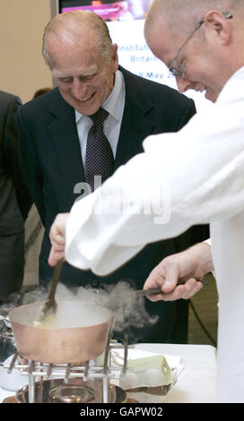 The Duke of Edinburgh smiles as chef Heston Blumenthal makes ice cream using liquid nitrogen during the Grand Launch of the Royal Institution of Great Britain, London. Stock Photo