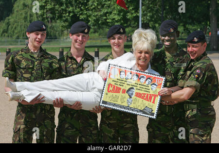 Carry On star Barbara Windsor joins soldiers from the Household Cavalry at Horseguards Parade in central London for the launch of a new set of stamps celebrating the 50th anniversary of the Carry On series of films and of the first Dracula movie by Hammer Films. Stock Photo