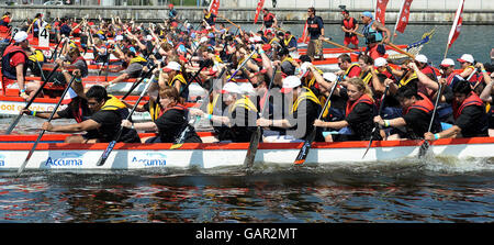 Chinese dragon boats competing during the annual London Dragon Boat Festival at the Royal Albert Docks in east London. Stock Photo