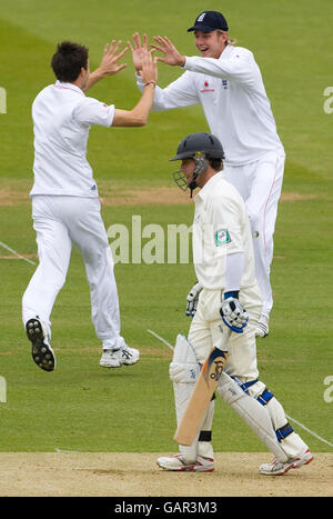 England's James Anderson celebrates with teammate Stuart Broad after dismissing New Zealand's Jamie How for 7 runs during the First npower Test Match at Lord's, London. Stock Photo