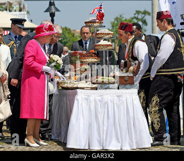 Britain's Queen Elizabeth II examines local food during a visit to Kabatas high school in Istanbul. It is the third day of the Queen's state visit to the Republic of Turkey.