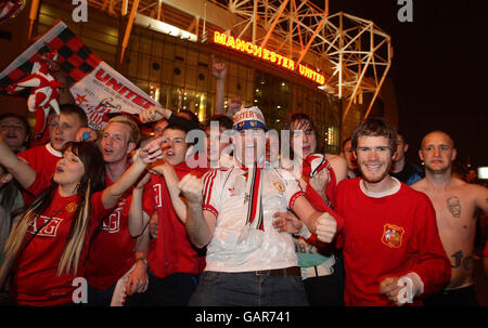 Manchester United fans celebrate outside the JJB stadium, Wigan, after
