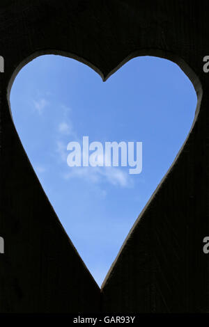heart-shaped hole in a board Stock Photo