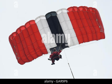 The Archbishop of York, Dr John Sentamu takes part in a sponsored parachute jump, with a member of the Red Devils parachute display team over Langar Airfield in Nottinghamshire. Stock Photo