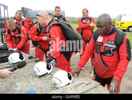 The Archbishop of York, Dr John Sentamu (right) prepares to board an aircraft to take part in a sponsored parachute jump, with a member of the Red Devils parachute display team over Langar Airfield in Nottinghamshire. Stock Photo