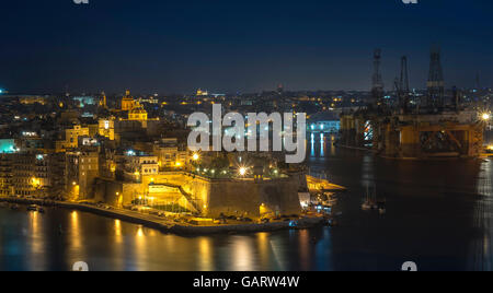Malta: Night view of the Three Cities across Grand Harbour from Valletta. Stock Photo