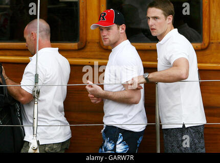 Manchester United and England footballer Wayne Rooney (centre) accompanied by friends gets off a private yacht in Ibiza Town port after spending the day onboard as part of his stag party. Stock Photo