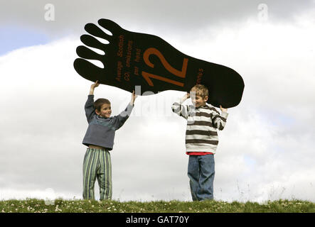 Tristan Nunn, 8 (right) and brother Charlie Nunn, 6, help Environment Secretary Richard Lochhead at Stirling Castle, Scotland, announce the project for Stirling to become the UK's first carbon neutral city. Stock Photo