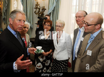 The Prince of Wales (left) talks to community volunteer workers from Norfolk during a reception for the Hope 08 initiative at Clarence House in central London. Stock Photo